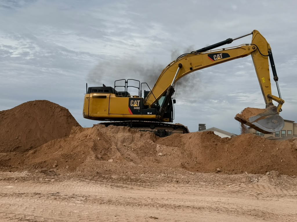 CAT excavator with the bucket raised